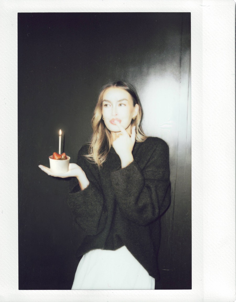 A birthday nice cream with a lit candle, in a Polaroid-style photo