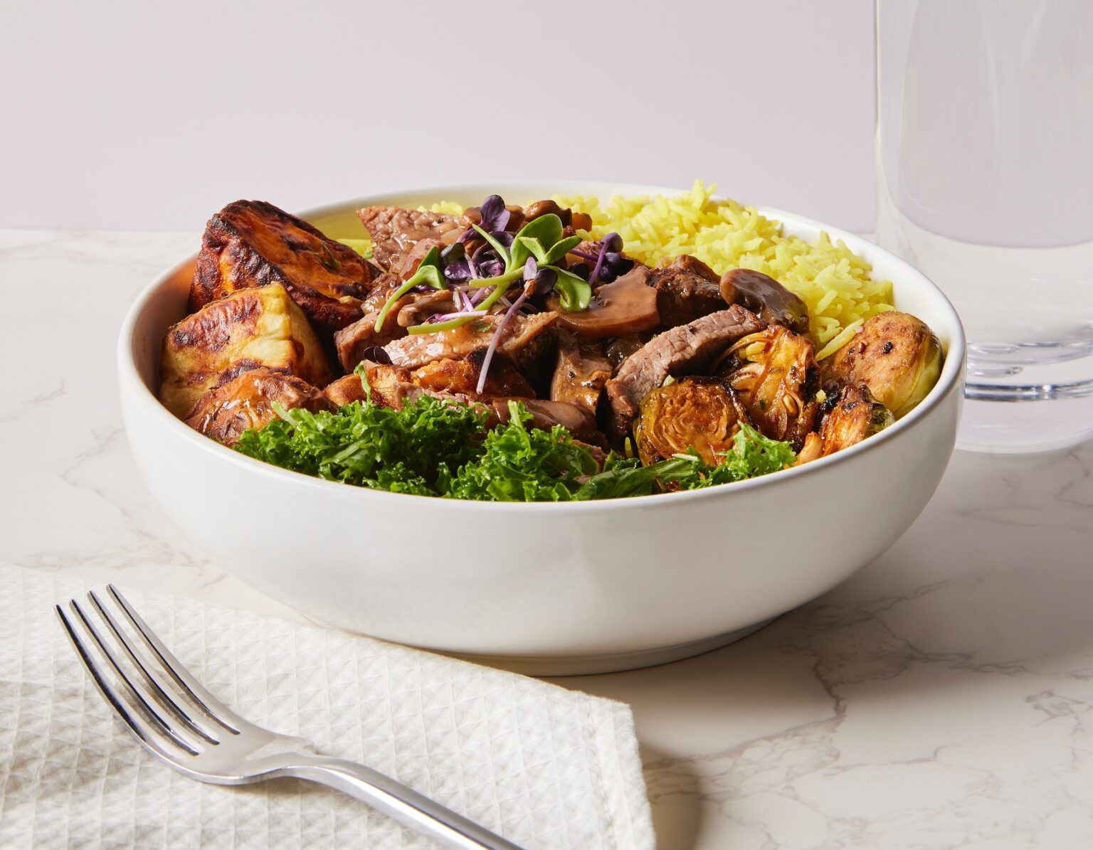 A bowl of steak, roasted vegetables and rice from Aubergine Kitchen
